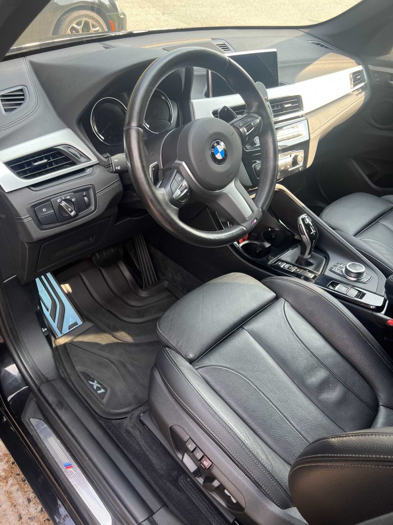 BMW X1 driver area with clean leather seat and console after interior detailing in Halifax, Nova Scotia.| Halifax Waterfront | deep vacuum | leather seat cleaning | dashboard cleaning