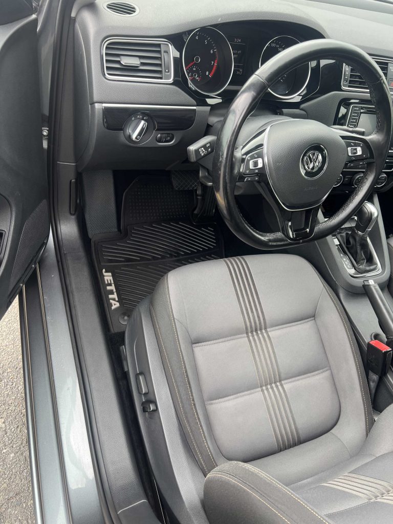 Volkswagen Jetta driver seat, wheel and footwell cleaned after interior detailing in Halifax, Nova Scotia.| Halifax Waterfront | deep vacuum | vinyl & plastic cleaning | door jamb cleaning