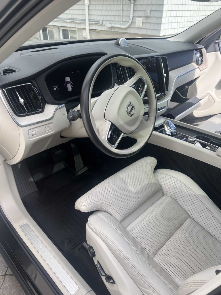 Volvo driver cockpit and leather seat refreshed after a detailing package, with clean dash and console.| none | leather seat cleaning | dashboard cleaning | interior wipe down