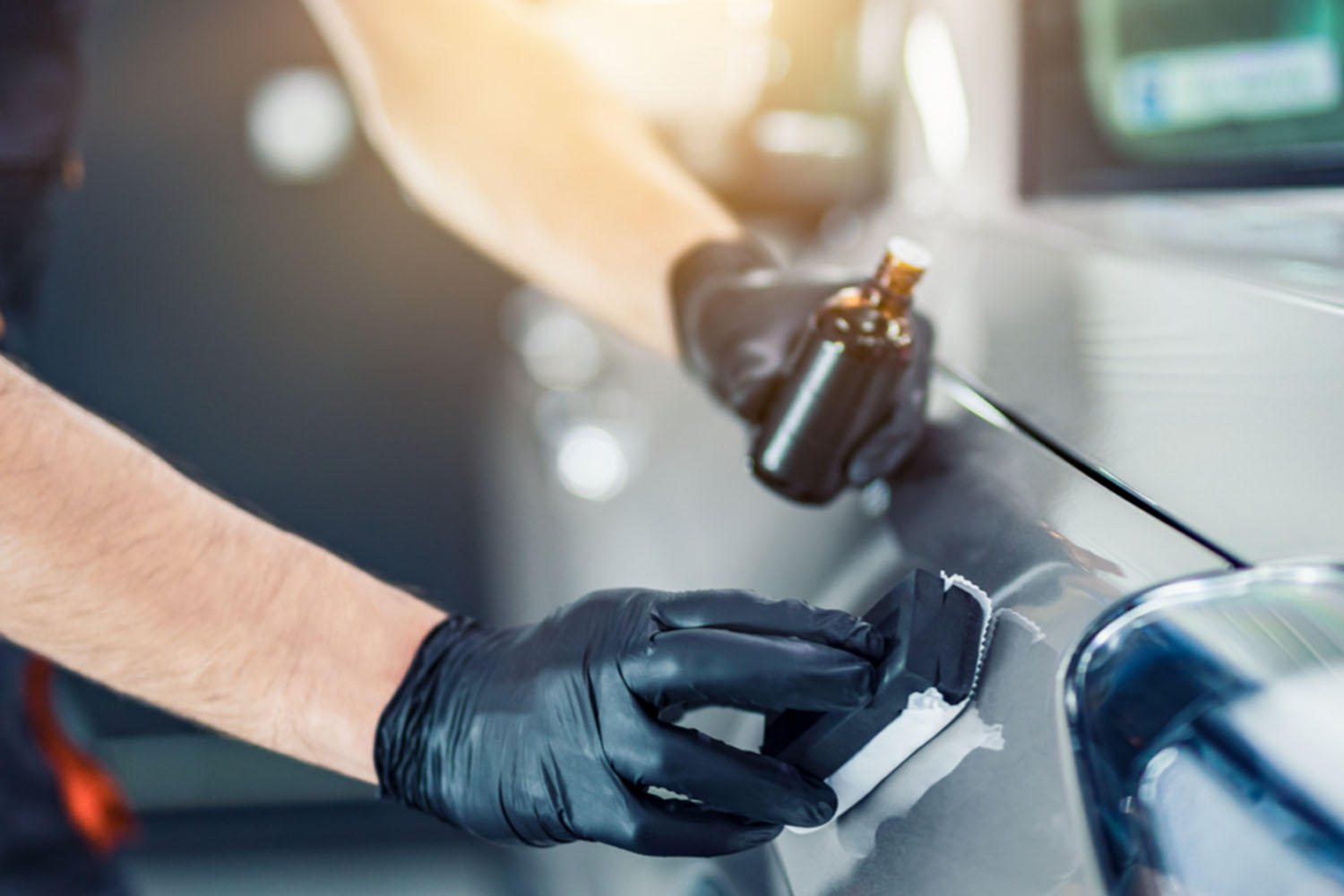 Gloved applicator spreads product on a car panel for ceramic coating in Timberlea for added protection.| none | paint prep | decontamination wash | hydrophobic protection