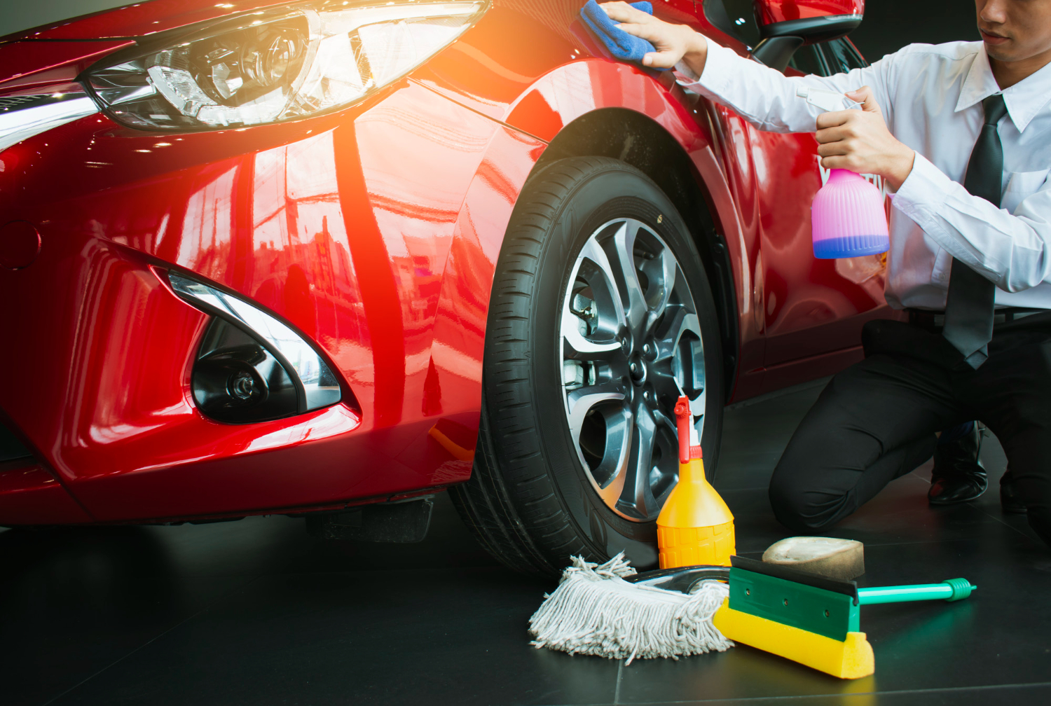 Technician wipes a red car fender with spray and a microfiber towel during exterior paint prep in Halifax, NS.| Halifax Waterfront | microfiber wipe down | panel prep spray | surface cleaning